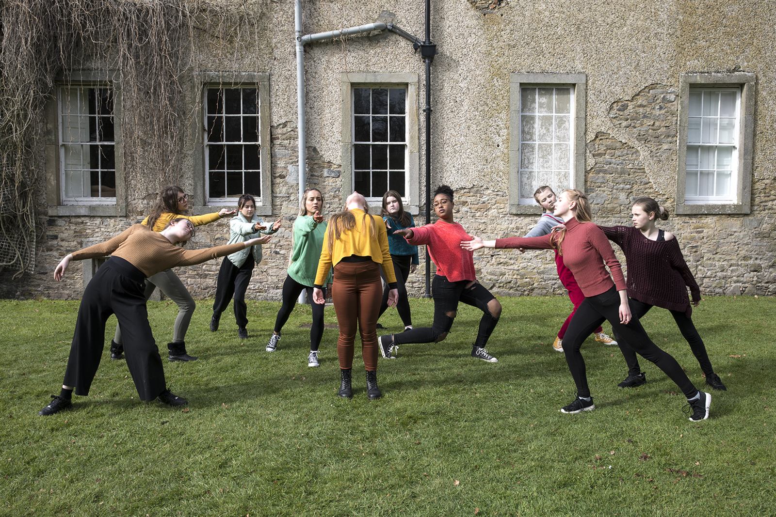 Laois Youth Dance Ensemble performing outdoors at a historic stone building